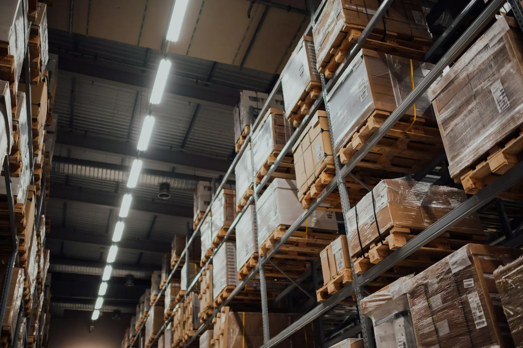Cardboard boxes on tall metal warehouse racks